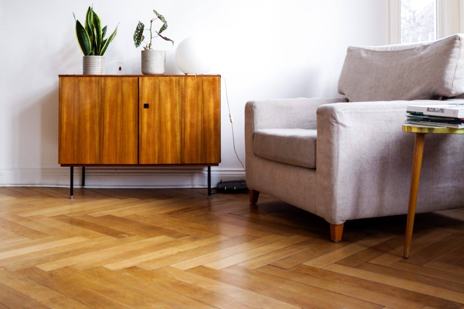 brown wooden table beside gray couch