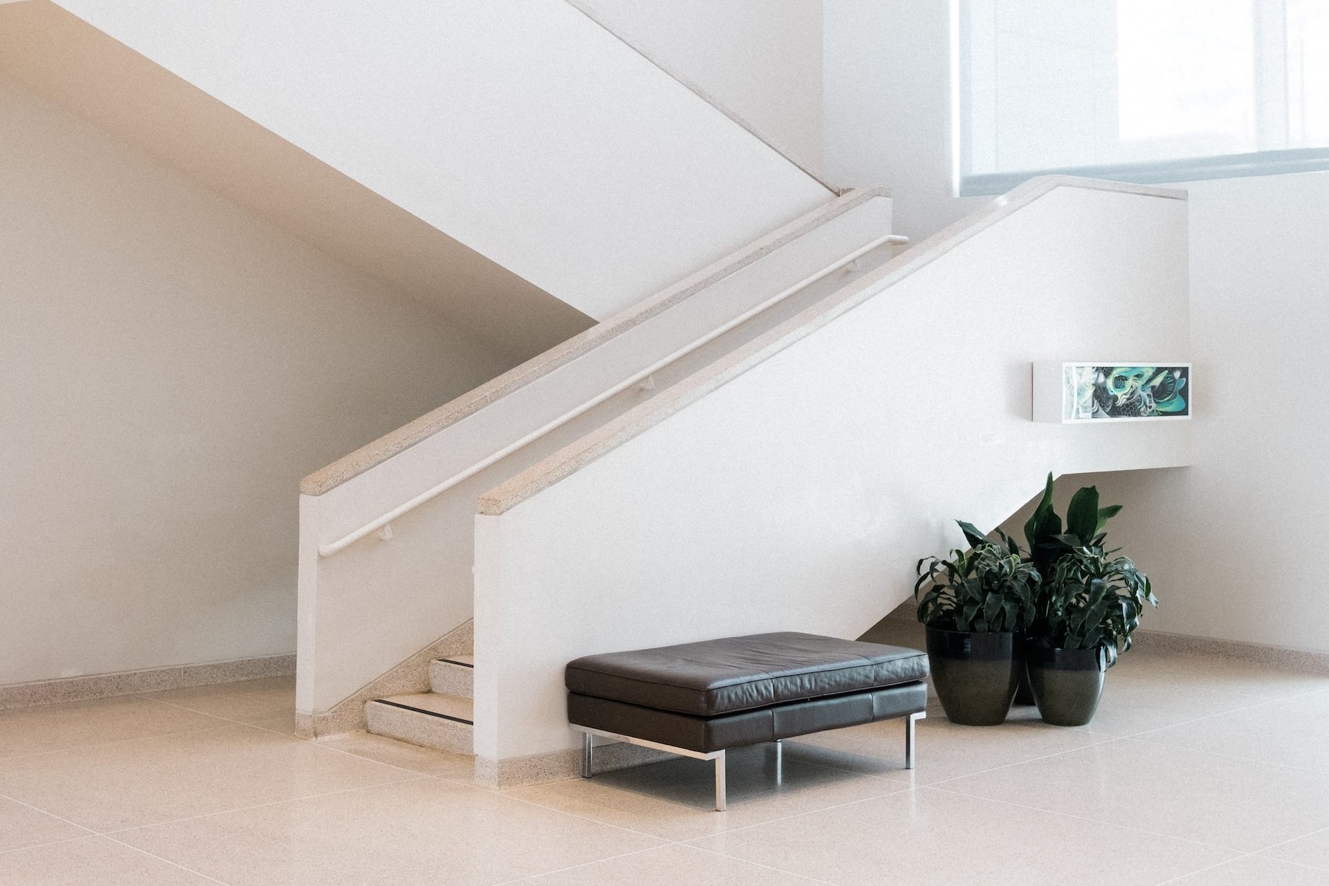 black leather padded chair in front of stair